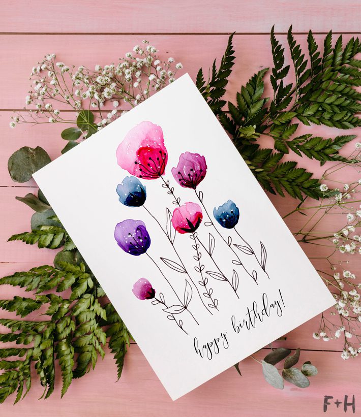 floral watercolor birthday card on flowers on pink background