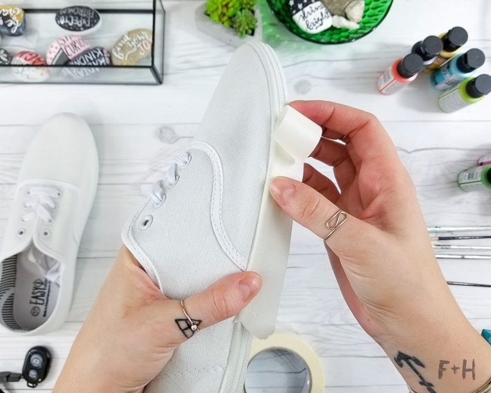 white canvas sneakers being painted