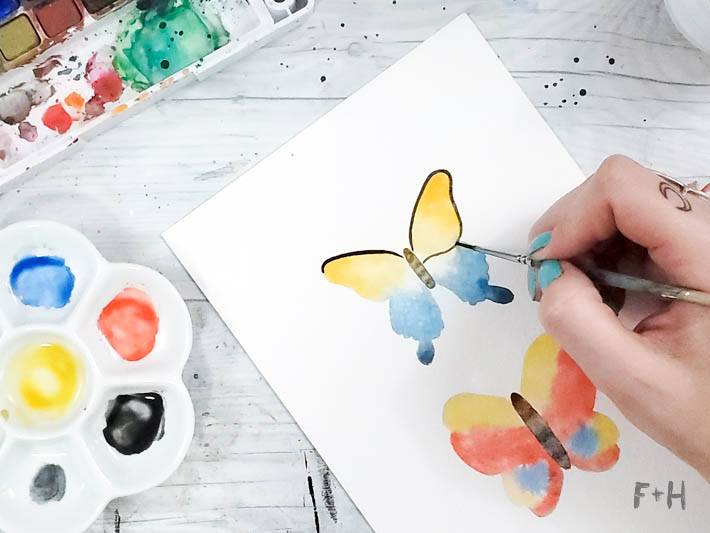 painting yellow and blue butterfly in watercolor