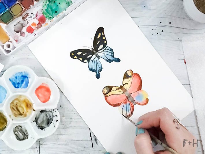painted watercolor butterflies on white desk